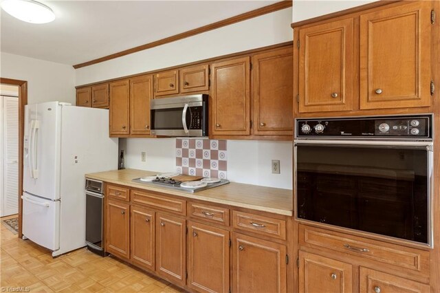 401 Joyce Rd, Hillsborough, NC 27278 - kitchen featuring brown cabinets, light countertops, and stainless steel appliances