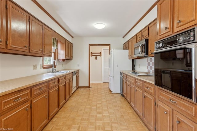 401 Joyce Rd, Hillsborough, NC 27278 - kitchen featuring light countertops, white appliances, baseboards, a sink, and brown cabinetry