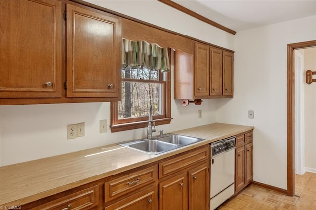 401 Joyce Rd, Hillsborough, NC 27278 - kitchen featuring dishwasher, light countertops, a sink, and brown cabinets