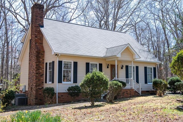 401 Joyce Rd, Hillsborough, NC 27278 - view of front of house with a chimney, central AC unit, crawl space, and a shingled roof