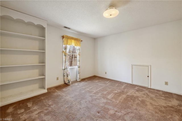 401 Joyce Rd, Hillsborough, NC 27278 - carpeted empty room with a textured ceiling, visible vents, and built in shelves