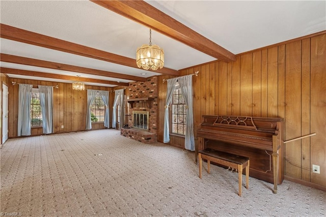 401 Joyce Rd, Hillsborough, NC 27278 - carpeted living area featuring a brick fireplace, a notable chandelier, wood walls, and beamed ceiling