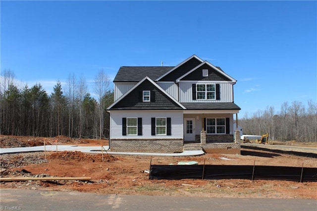 craftsman-style house with board and batten siding and brick siding