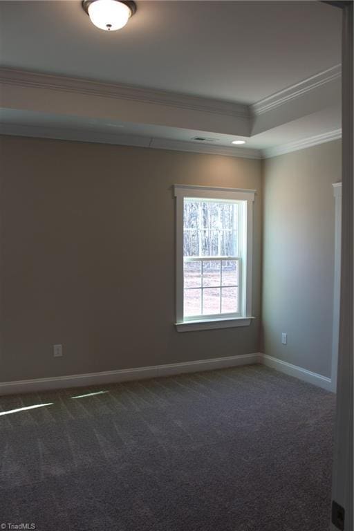 carpeted empty room featuring baseboards, a raised ceiling, and crown molding