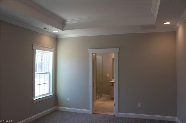 unfurnished bedroom with recessed lighting, light carpet, baseboards, ornamental molding, and a tray ceiling