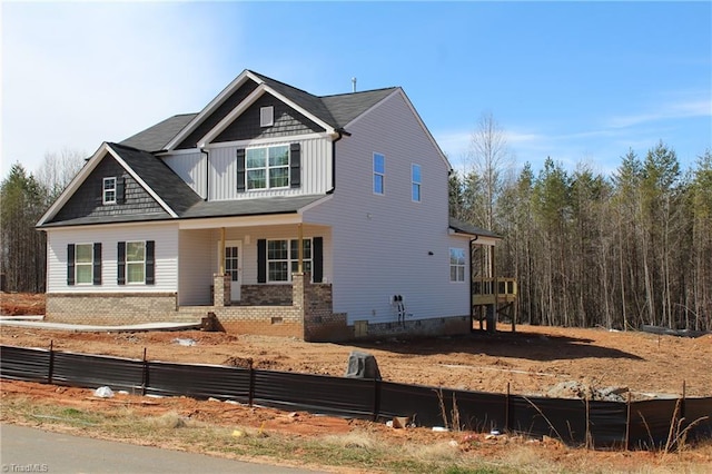 view of front of house featuring crawl space, board and batten siding, and brick siding