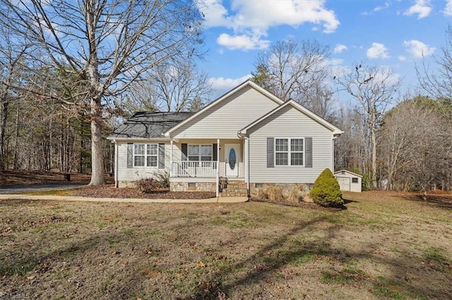 single story home featuring a storage shed, covered porch, and a front lawn