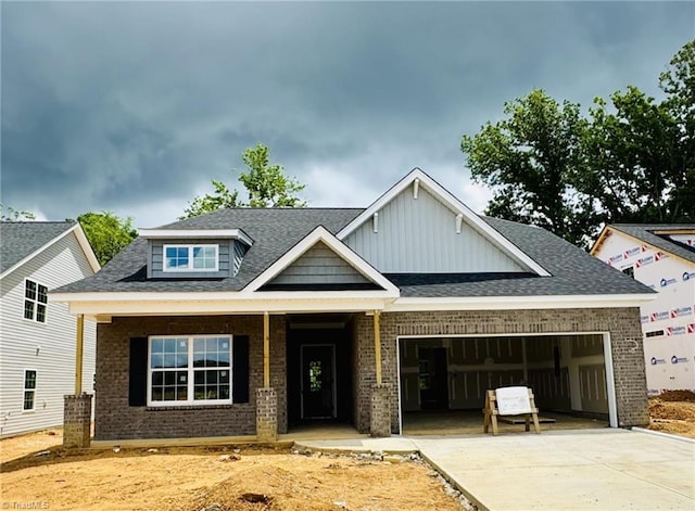 1085 Fairhaven Dr Lot # 49, Mebane, NC 27302 - craftsman-style house with brick siding, an attached garage, driveway, a porch, and a shingled roof
