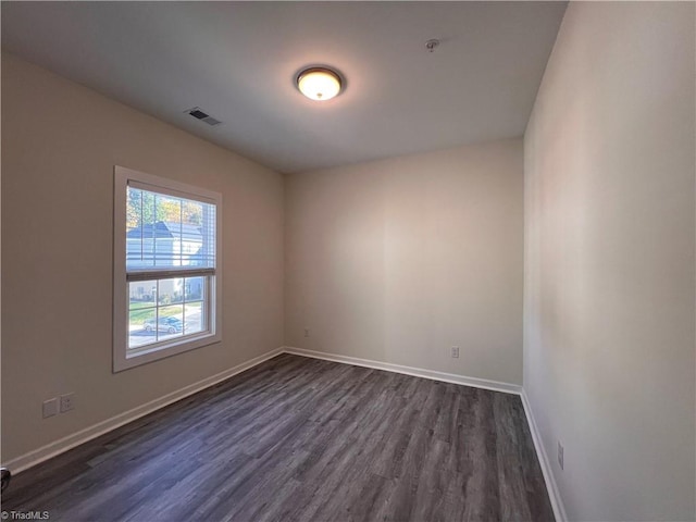 spare room featuring dark hardwood / wood-style floors