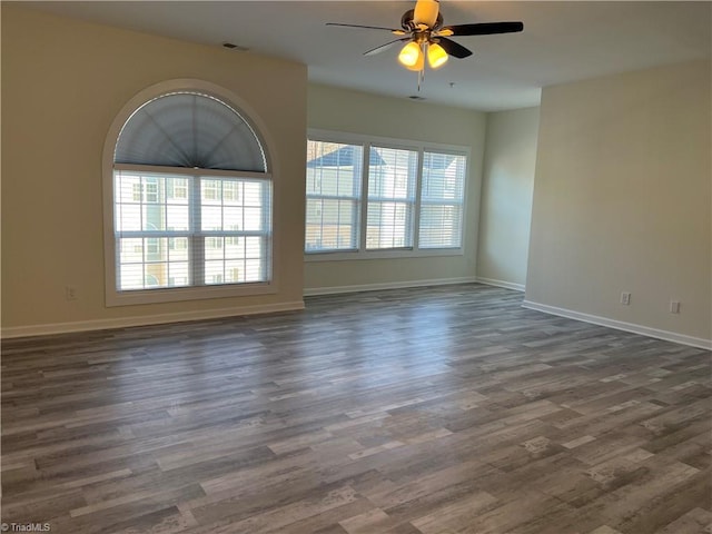 spare room featuring dark hardwood / wood-style floors and ceiling fan