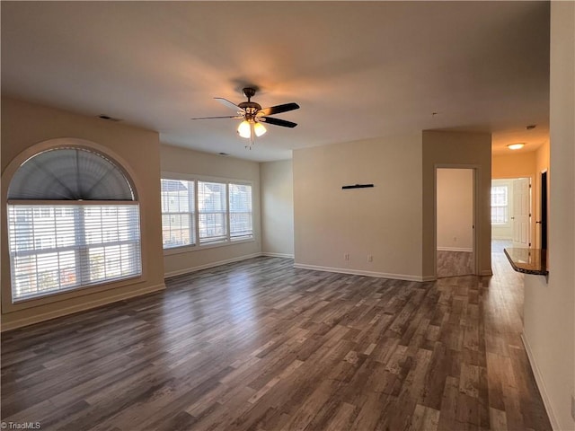 spare room featuring ceiling fan and dark wood-type flooring