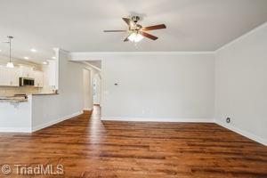 2834 Fallin Ct, High Point, NC 27262 - unfurnished living room featuring wood finished floors, crown molding, and ceiling fan
