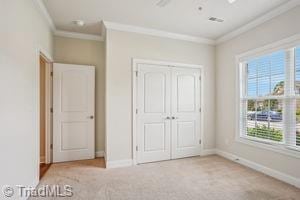 2834 Fallin Ct, High Point, NC 27262 - unfurnished bedroom with ornamental molding, a closet, and carpet