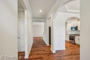 2834 Fallin Ct, High Point, NC 27262 - hallway with ornamental molding, wood finished floors, arched walkways, and recessed lighting