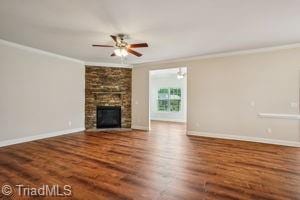 2834 Fallin Ct, High Point, NC 27262 - unfurnished living room with crown molding, a ceiling fan, wood finished floors, and a large fireplace