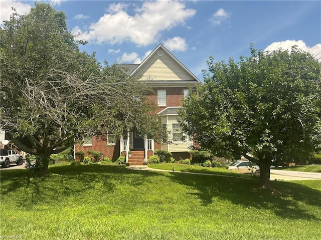 1205 Cane Ridge Ln, Lewisville, NC 27023 - view of front facade featuring brick siding and a front lawn