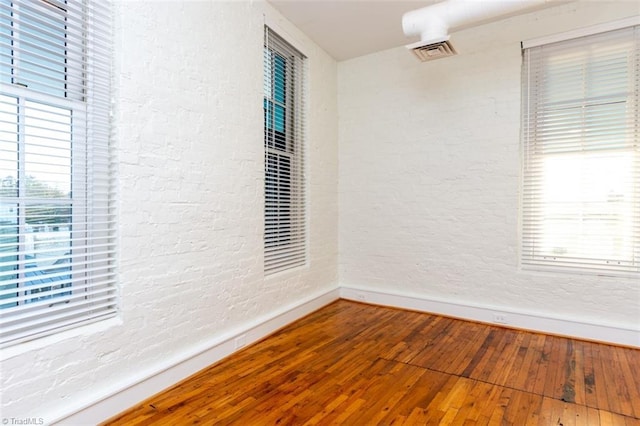 spare room with hardwood / wood-style floors