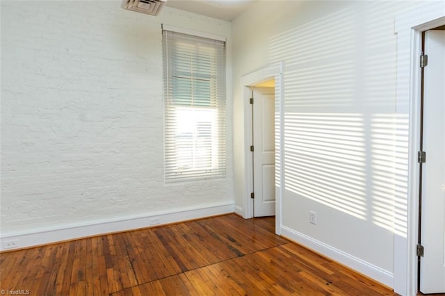 spare room with hardwood / wood-style flooring