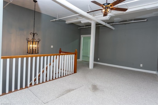 spare room featuring ceiling fan with notable chandelier