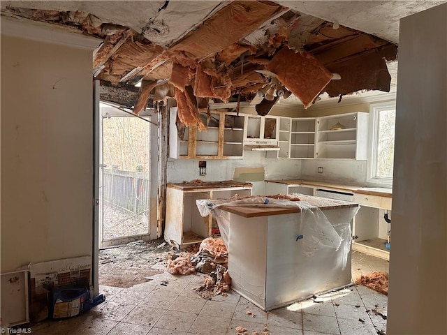 kitchen featuring under cabinet range hood and open shelves