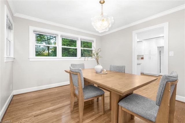 dining area with baseboards, light wood-style flooring, a chandelier, and crown molding