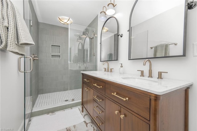 full bathroom featuring a stall shower, double vanity, and marble finish floors