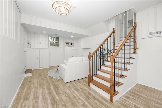 living room featuring wood finished floors and stairs