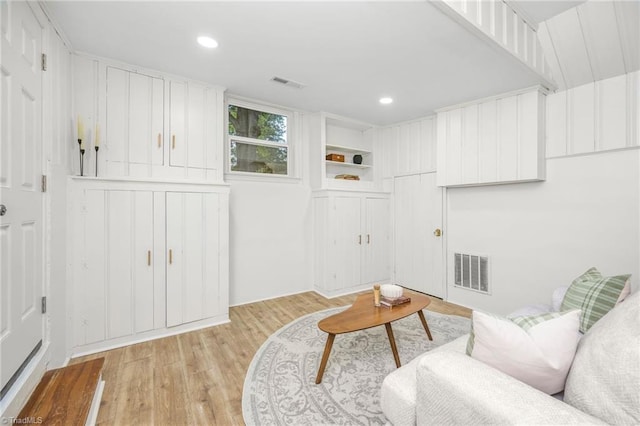 living area with light wood-type flooring and recessed lighting