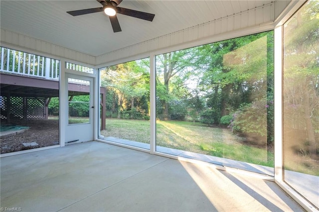 unfurnished sunroom with a ceiling fan