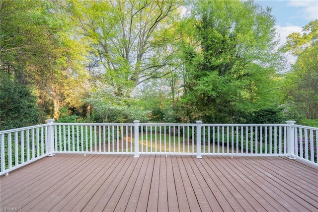 wooden deck with view of wooded area