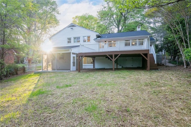rear view of house with a carport, stairway, a chimney, and a wooden deck