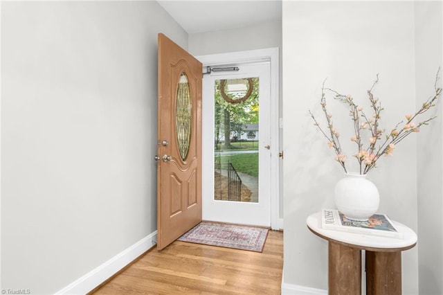 entryway with light wood-style floors and baseboards