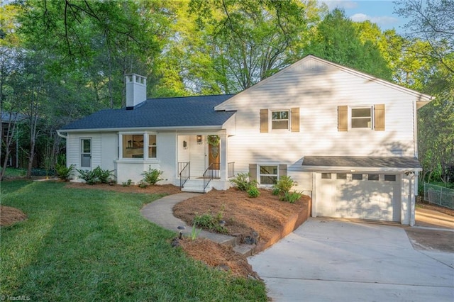 tri-level home with concrete driveway, a garage, a front lawn, a chimney, and a shingled roof