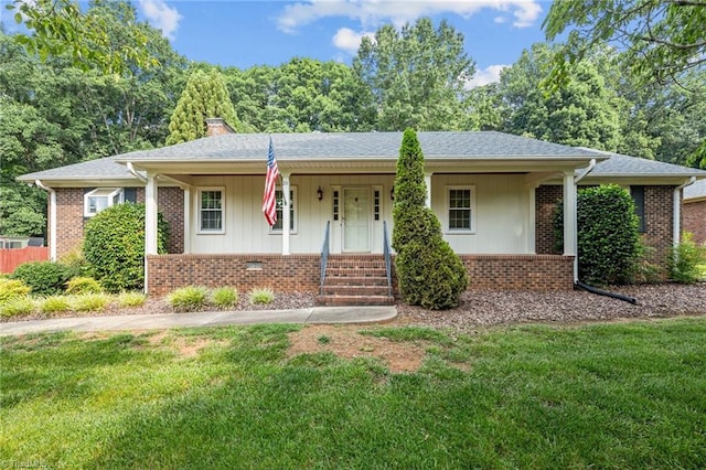 211 Forestview Dr, Elon, NC 27244 - ranch-style house featuring covered porch, a front lawn, brick siding, and a chimney