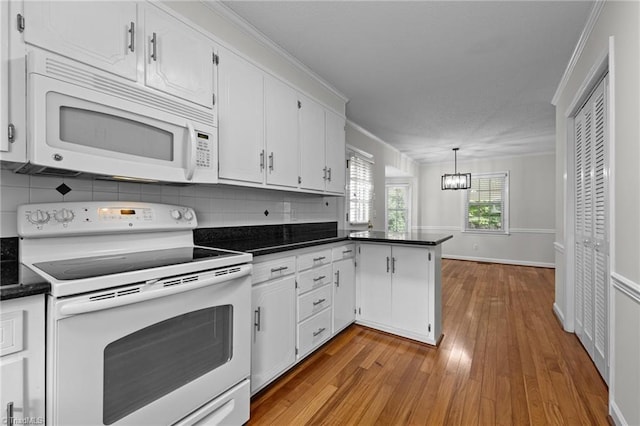 211 Forestview Dr, Elon, NC 27244 - kitchen featuring white appliances, dark countertops, hardwood / wood-style flooring, white cabinets, and crown molding