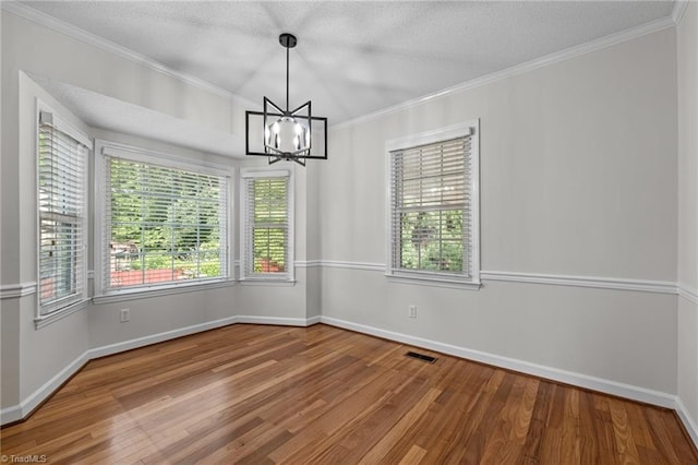 211 Forestview Dr, Elon, NC 27244 - spare room with wood finished floors, a chandelier, crown molding, and a textured ceiling