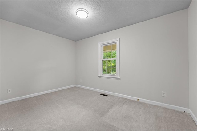 211 Forestview Dr, Elon, NC 27244 - empty room with carpet floors and a textured ceiling