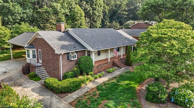 211 Forestview Dr, Elon, NC 27244 - view of front of property featuring a chimney, brick siding, concrete driveway, roof with shingles, and an attached carport