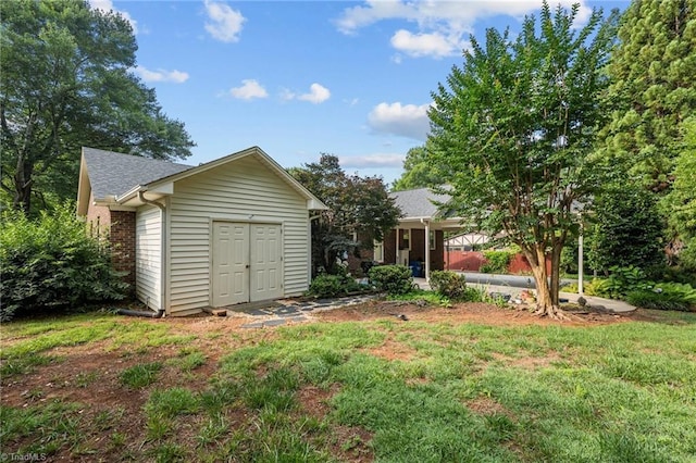 211 Forestview Dr, Elon, NC 27244 - back of house with an outbuilding, a yard, and roof with shingles