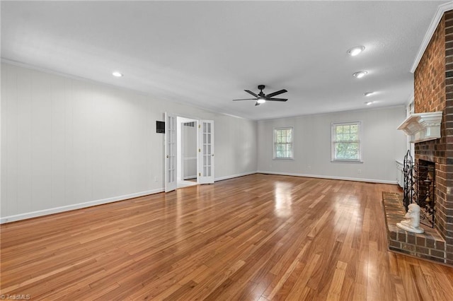 211 Forestview Dr, Elon, NC 27244 - unfurnished living room with ceiling fan, a fireplace, wood finished floors, crown molding, and recessed lighting