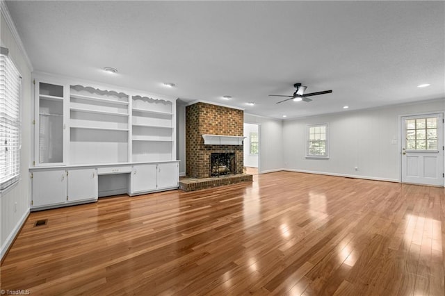211 Forestview Dr, Elon, NC 27244 - unfurnished living room with a ceiling fan, light wood-style flooring, a fireplace, ornamental molding, and recessed lighting