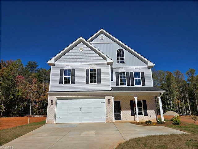 view of front of property with a porch and a garage