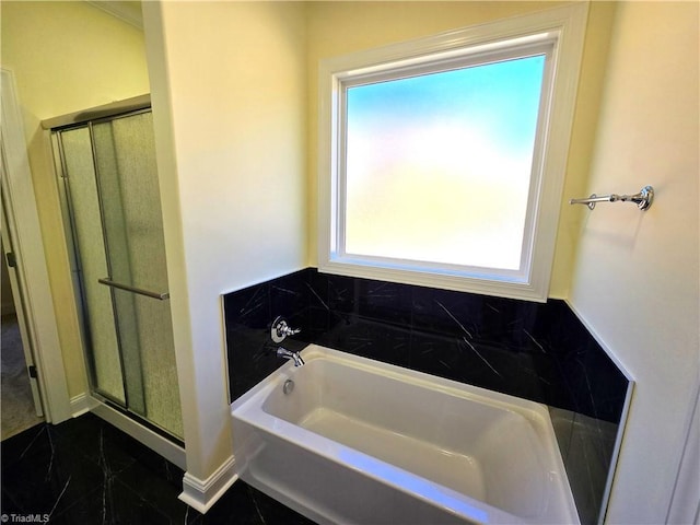 bathroom with plus walk in shower and a wealth of natural light