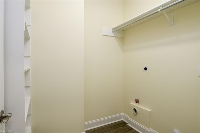 clothes washing area featuring dark hardwood / wood-style floors and hookup for an electric dryer