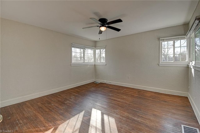 unfurnished room featuring dark wood-type flooring and ceiling fan