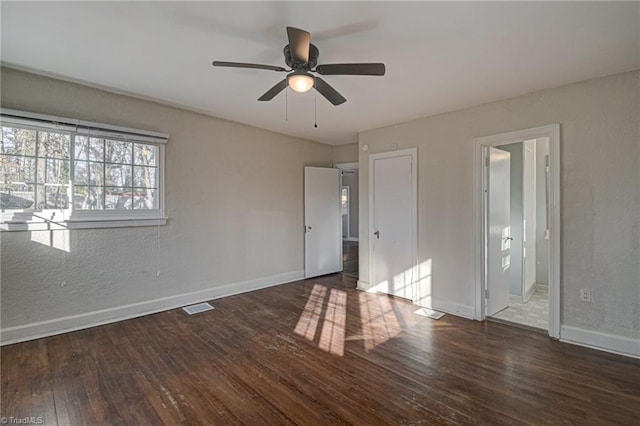 unfurnished bedroom featuring dark hardwood / wood-style flooring and ceiling fan