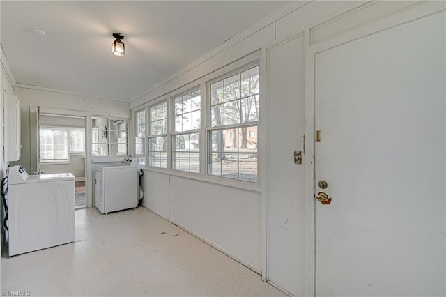 laundry area featuring crown molding and separate washer and dryer