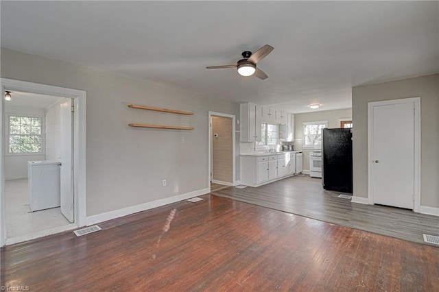 unfurnished living room with ceiling fan and dark hardwood / wood-style floors