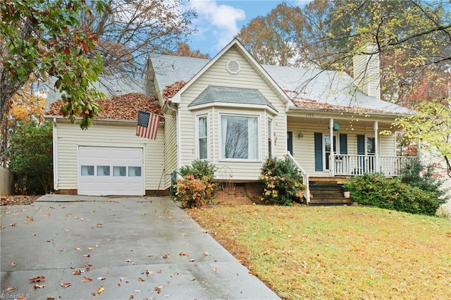 bungalow-style house featuring covered porch, a garage, and a front lawn