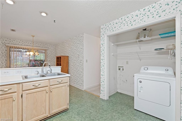 laundry room with washer / dryer, sink, and a chandelier